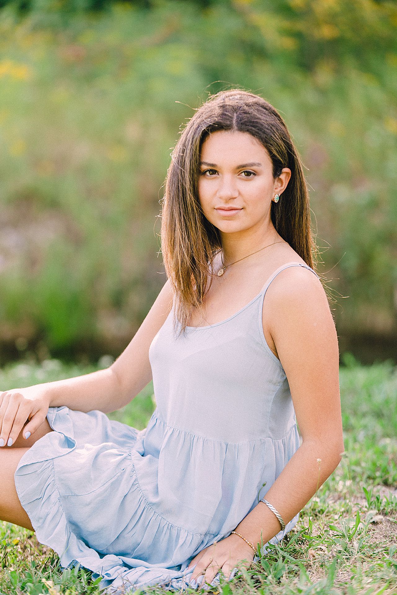 Young woman posing for her senior portraits in Bay Harbor, Michigan