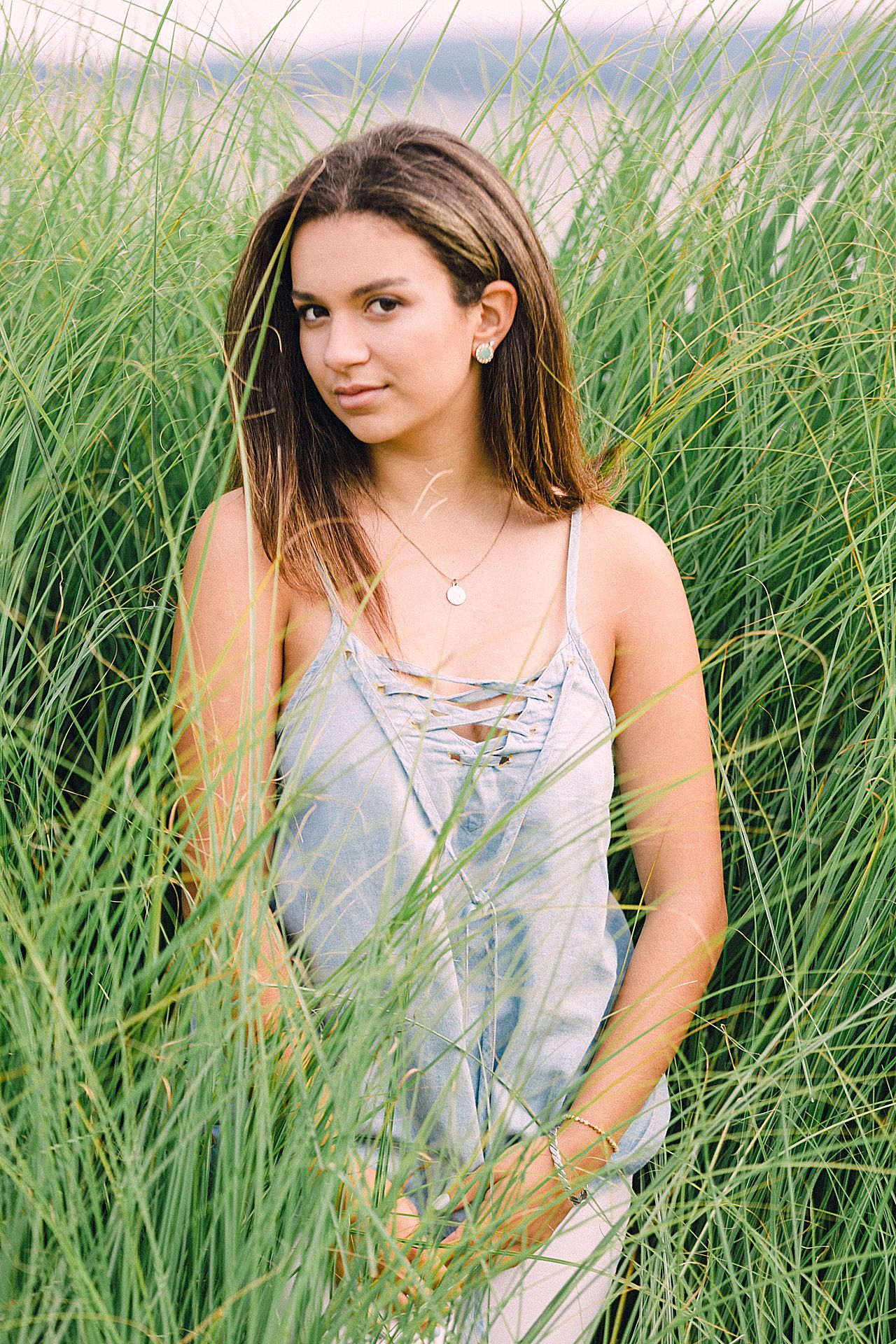 Teenager in the tall, beach grass of Bay Harbor, Michigan