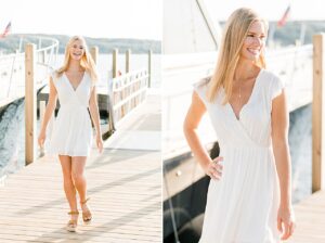 This is a photo of a high school senior girl walking on a dock at the marina in Boyne City, Michigan