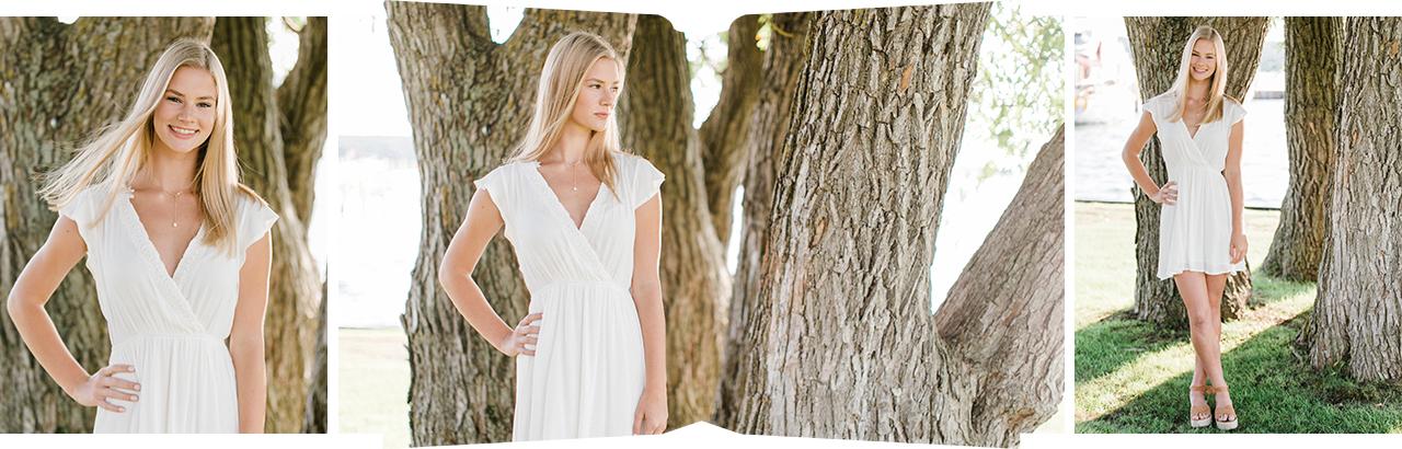 This is a high school senior girl taking portraits by a willow tree near the lake