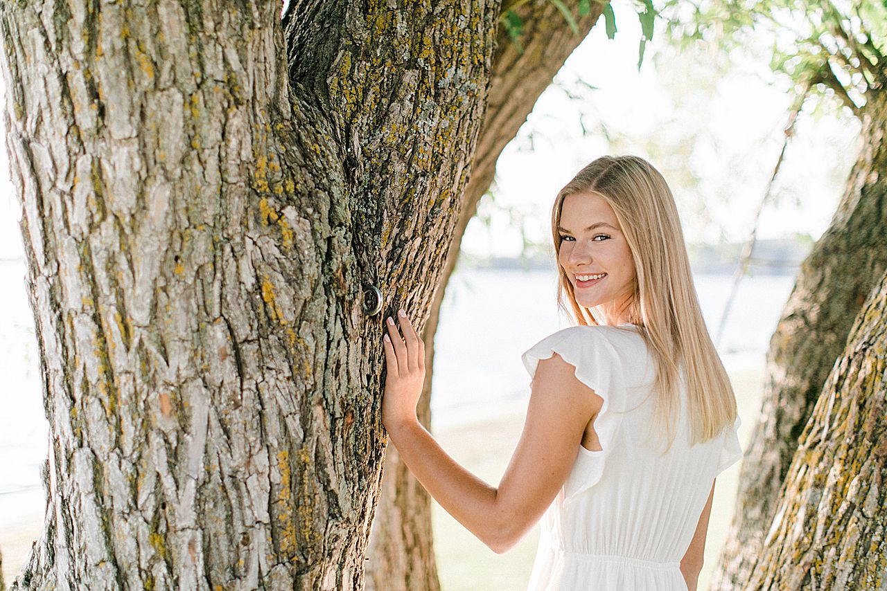 This is a high school senior taking portraits near a lake