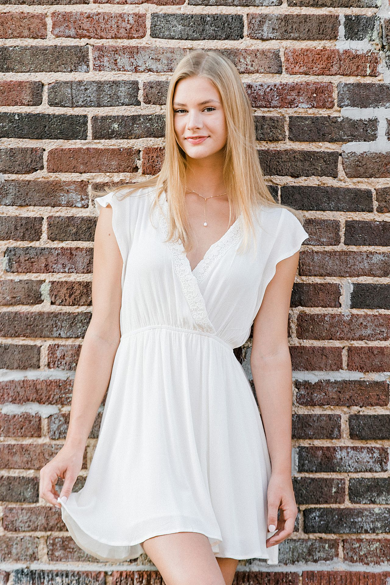 This is a photo of a high school senior girl in downtown Boyne City, MI