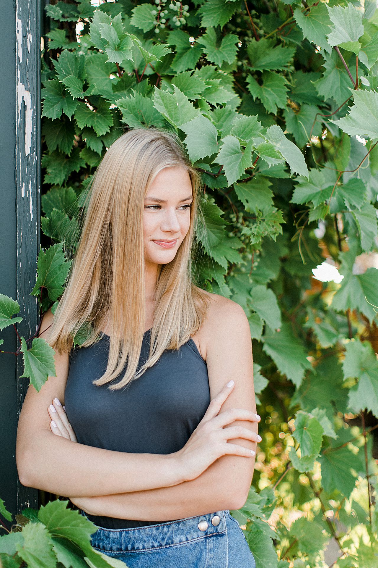 This is a high school senior girl in Northern Michigan with vines in the background