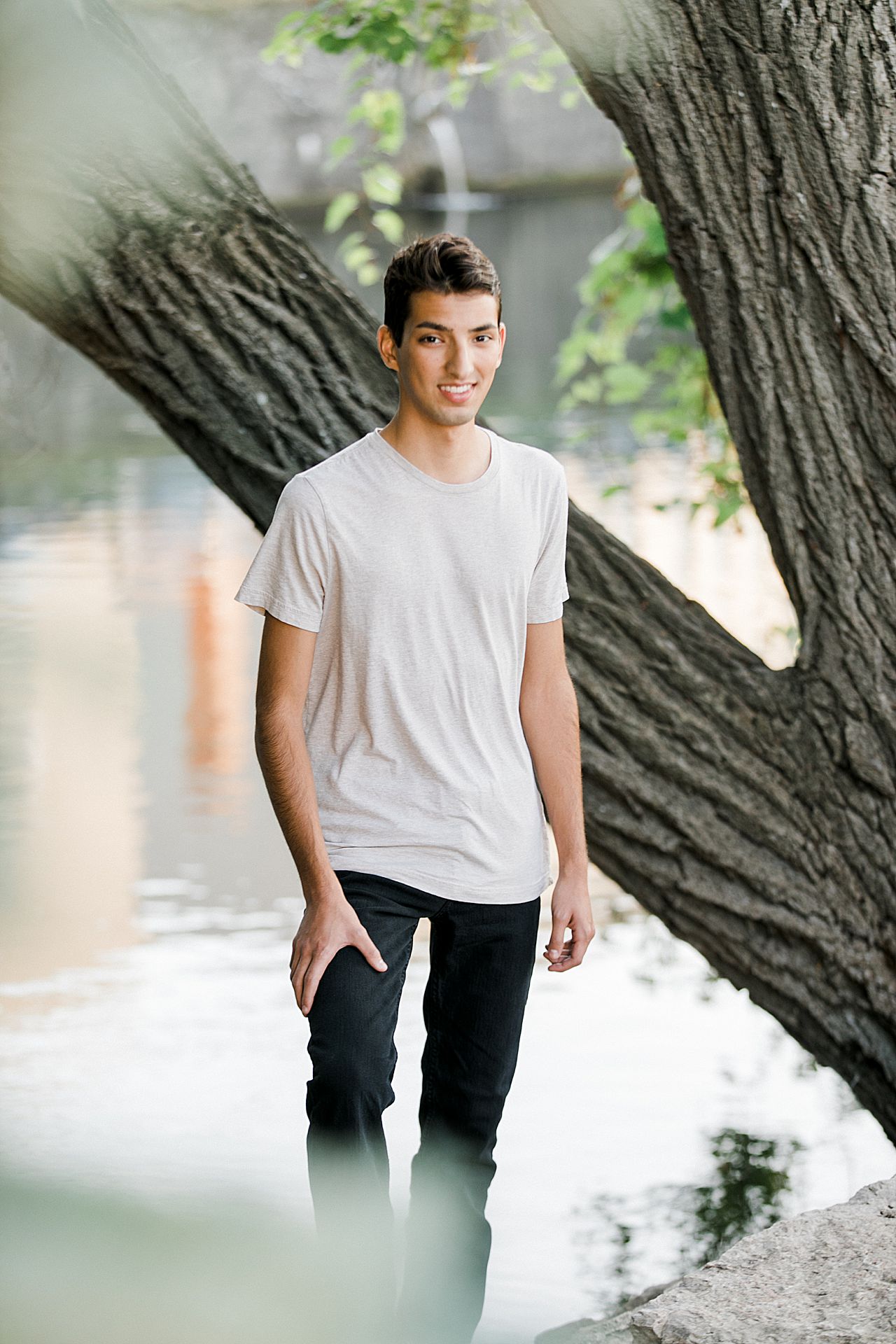High school senior boy near a river in downtown Traverse City