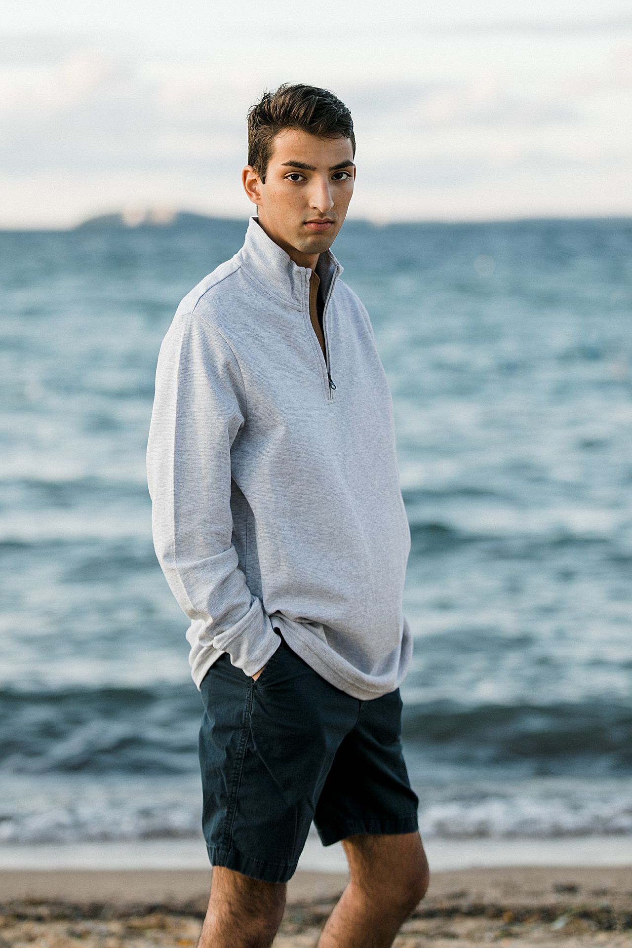 A senior portrait by a lake at sunset in Northern Michigan