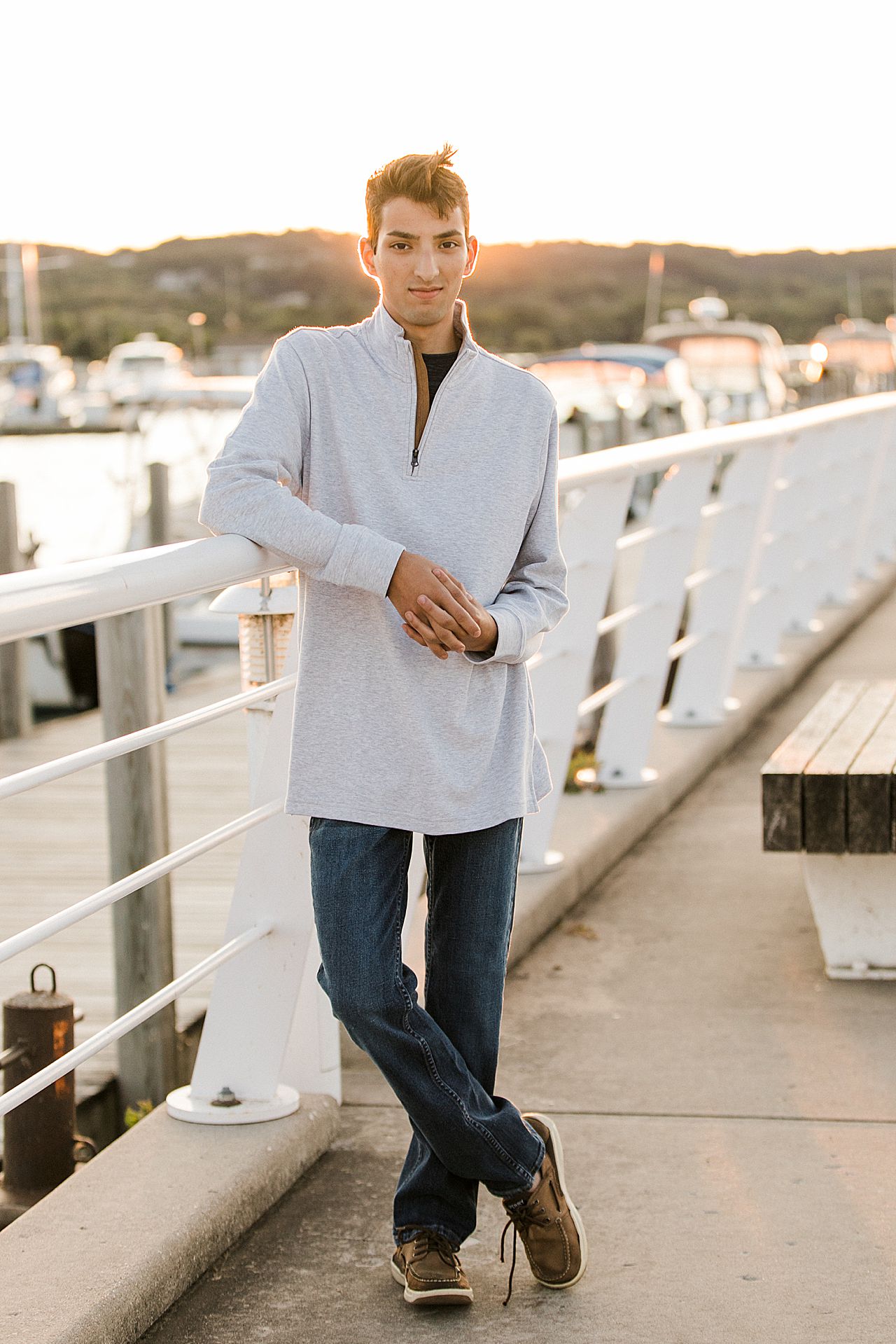 Teenage boy at a marina during sunset in Northern Michigan