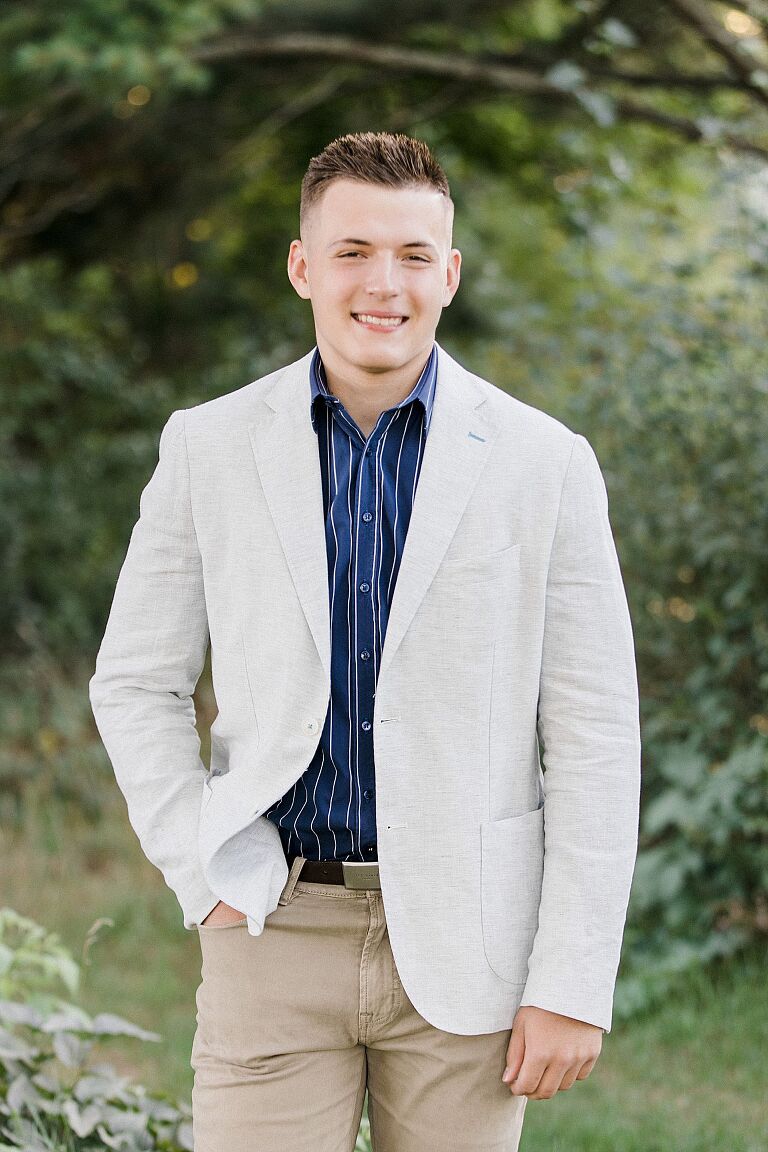 This is a photo of a senior portrait in Traverse City, Michigan near the woods