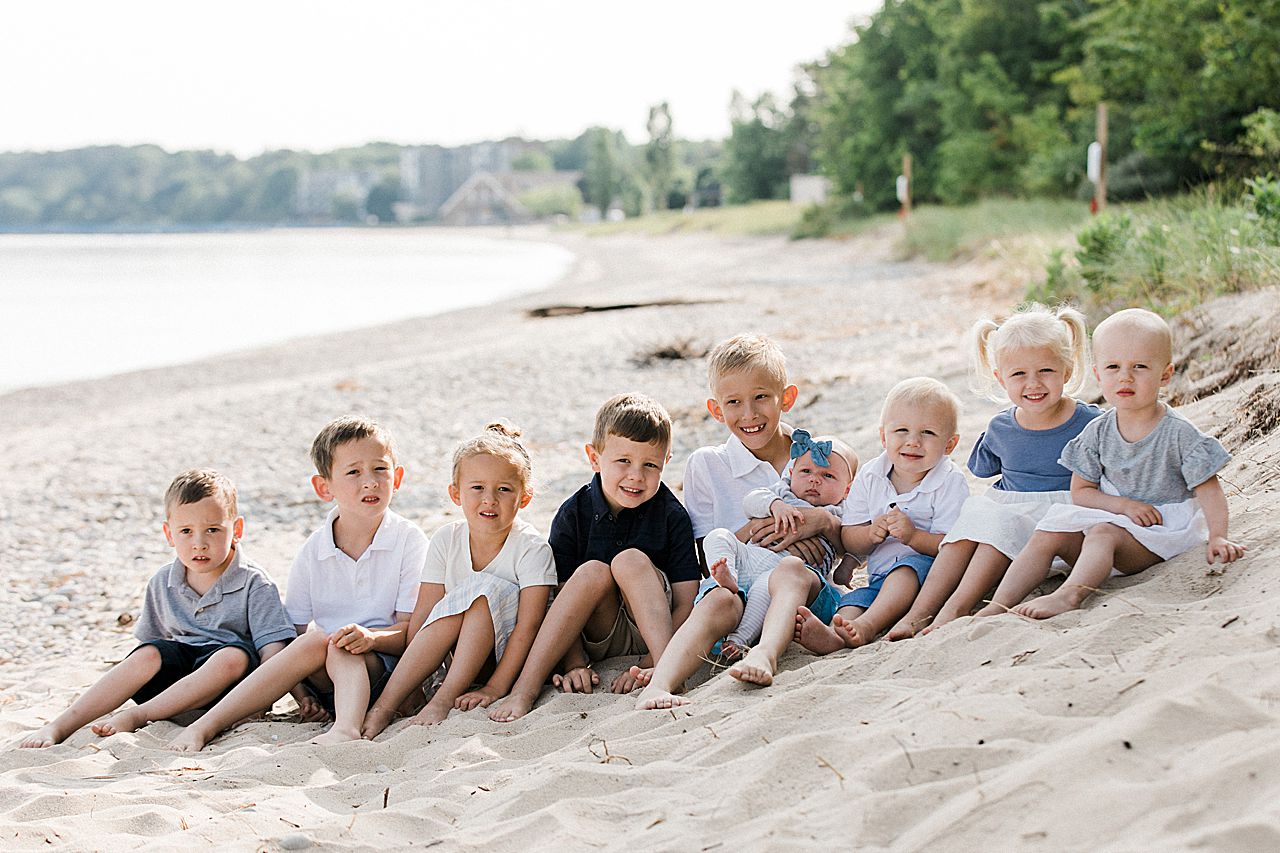 Cousins sitting on a beach in Charlevoix, Michigan