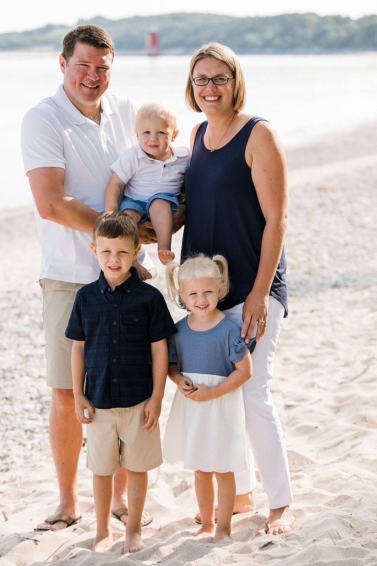 Parents with their three kids on a beach in Michigan