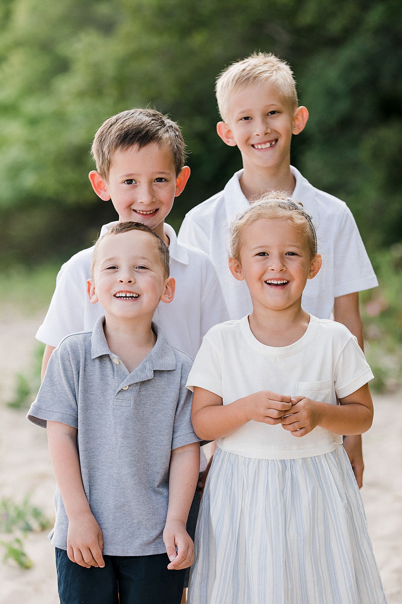 Sister with her three brothers on a beach in Northern Michigan