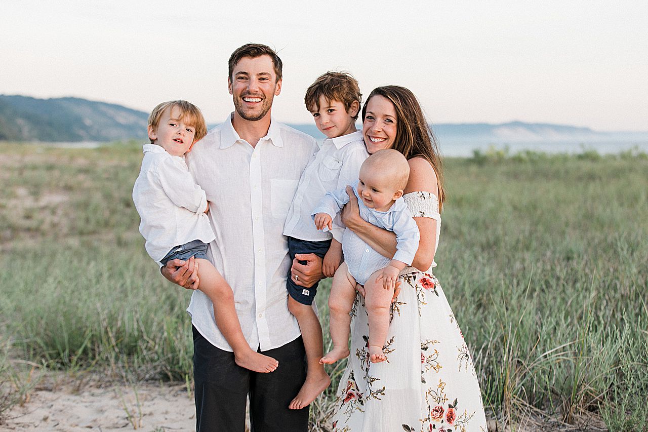 Parents holding their three boys on a the coast of Frankfort, Michigan