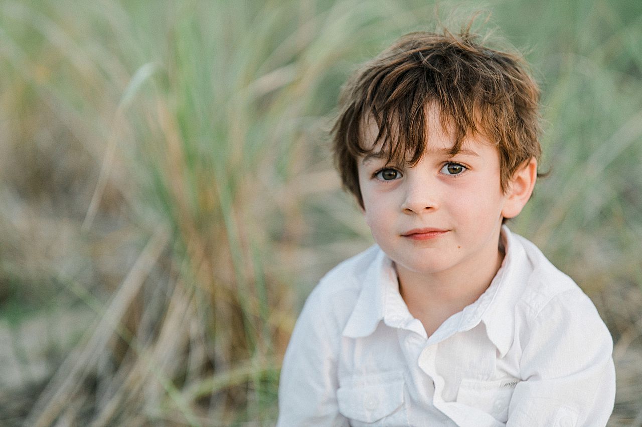 A young boy sitting and looking at the camera in Northern Michigan