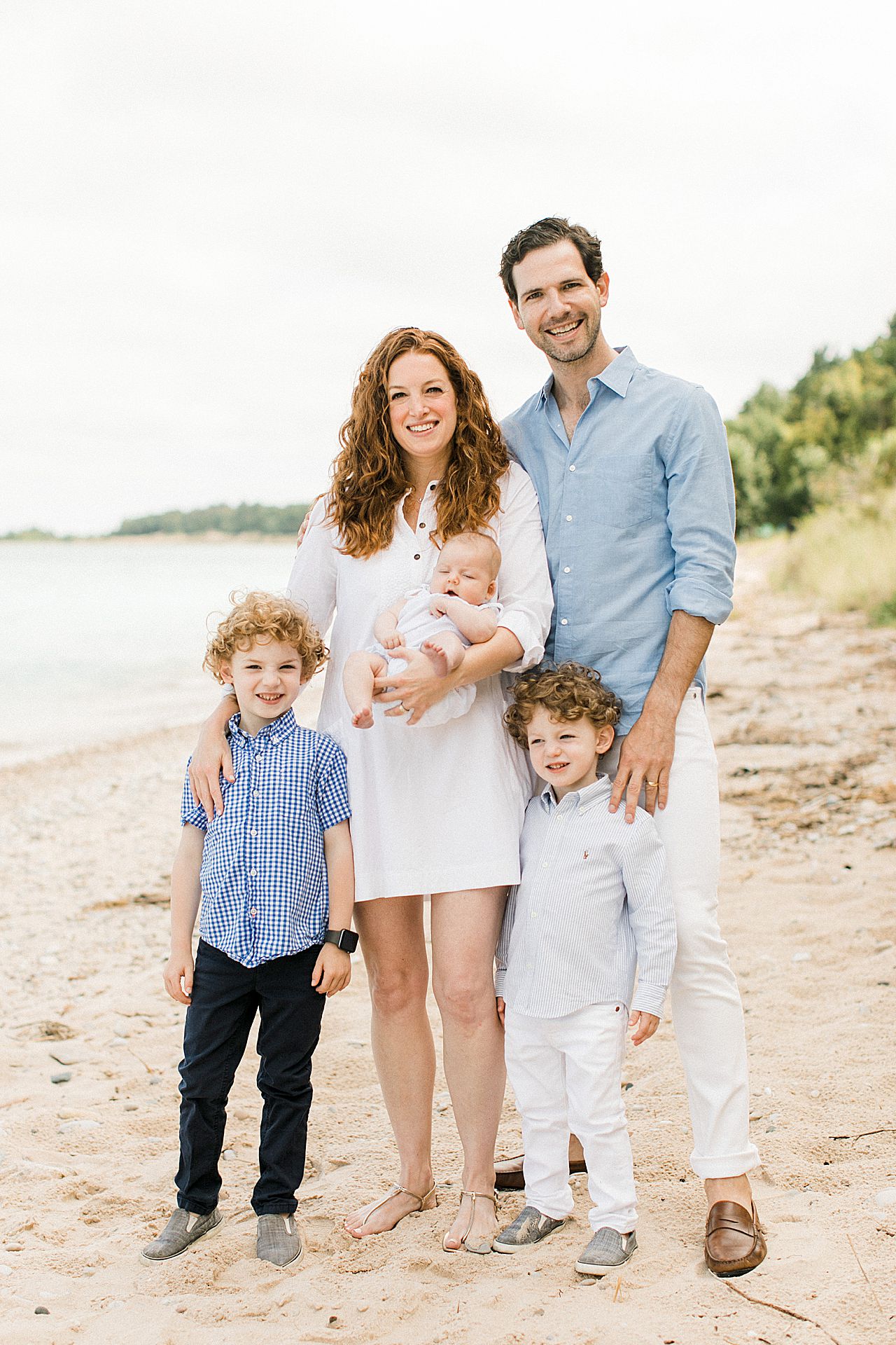 Mom and dad with their three kids on the beach