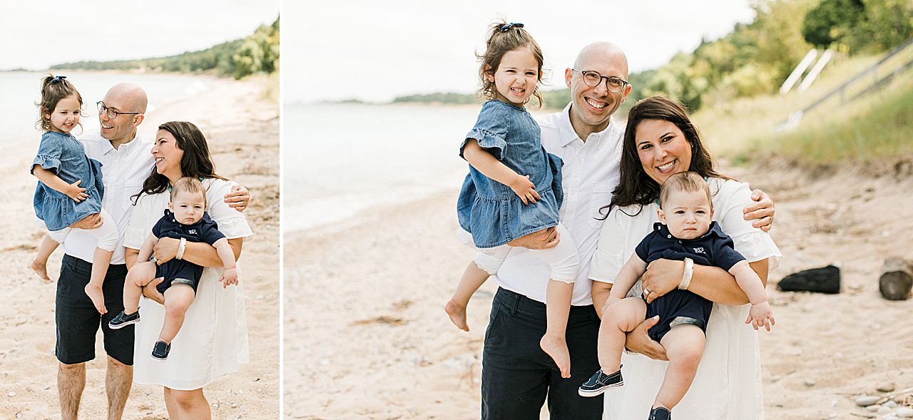 Mother and father carrying their two young kids