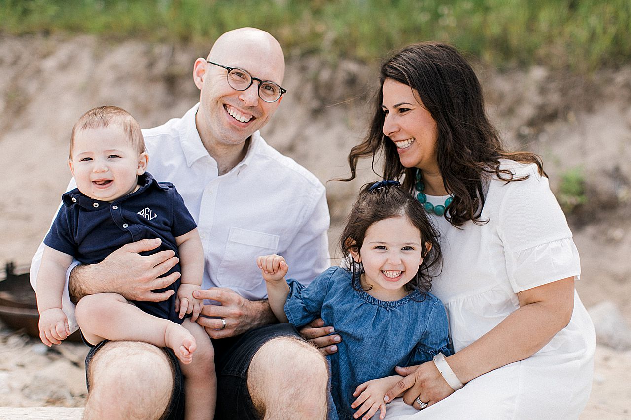 Parents with their young kids laughing and smiling together