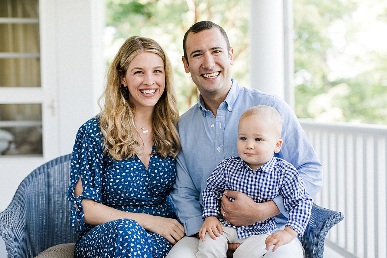 Young family smiling on a porch in Northern Michigan
