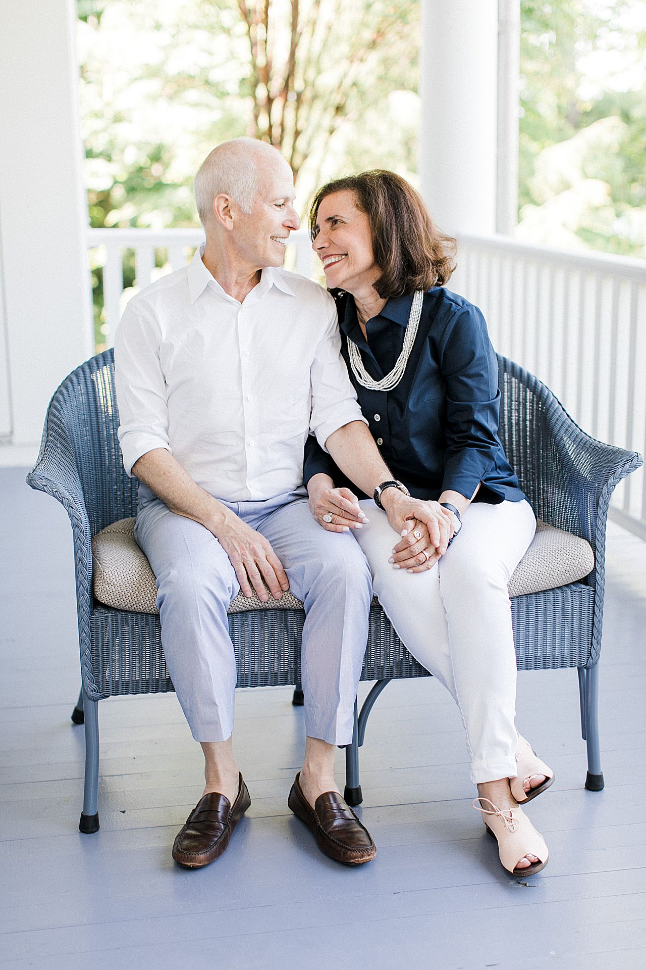 Grandparents enjoying each others company on a porch in Northern Michigan