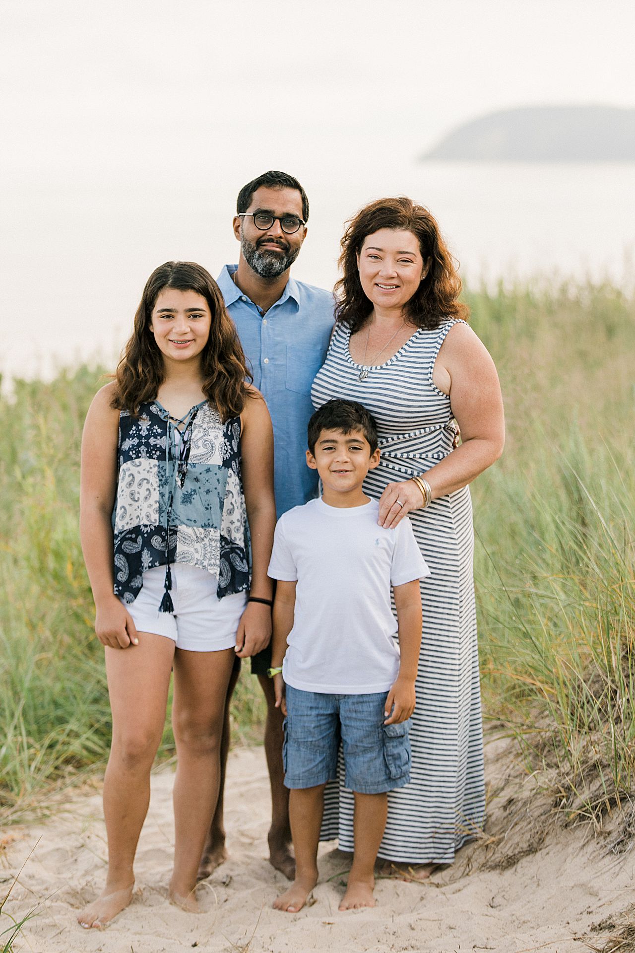 Parents with their two kids on a beach in Lake Leelanau, Michigan