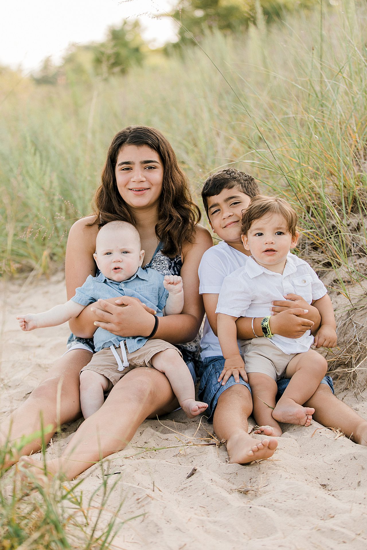 Cousins sitting on a beach in Michigan