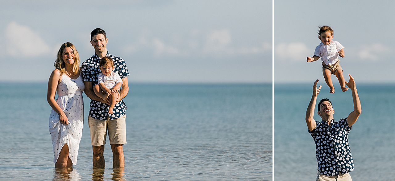 Young family standing in Lake Michigan and a father tossing his son in the air