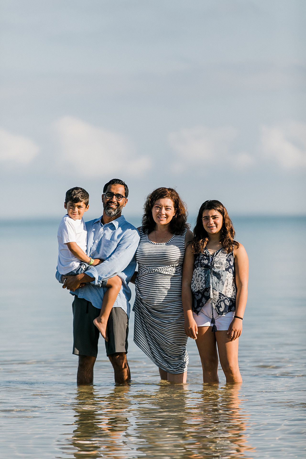 Mother and father standing with their son and daughter in Lake Leelanau, Michigan