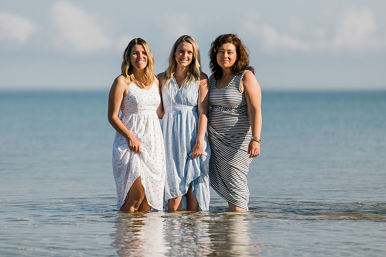 Three sisters standing in Lake Michigan together