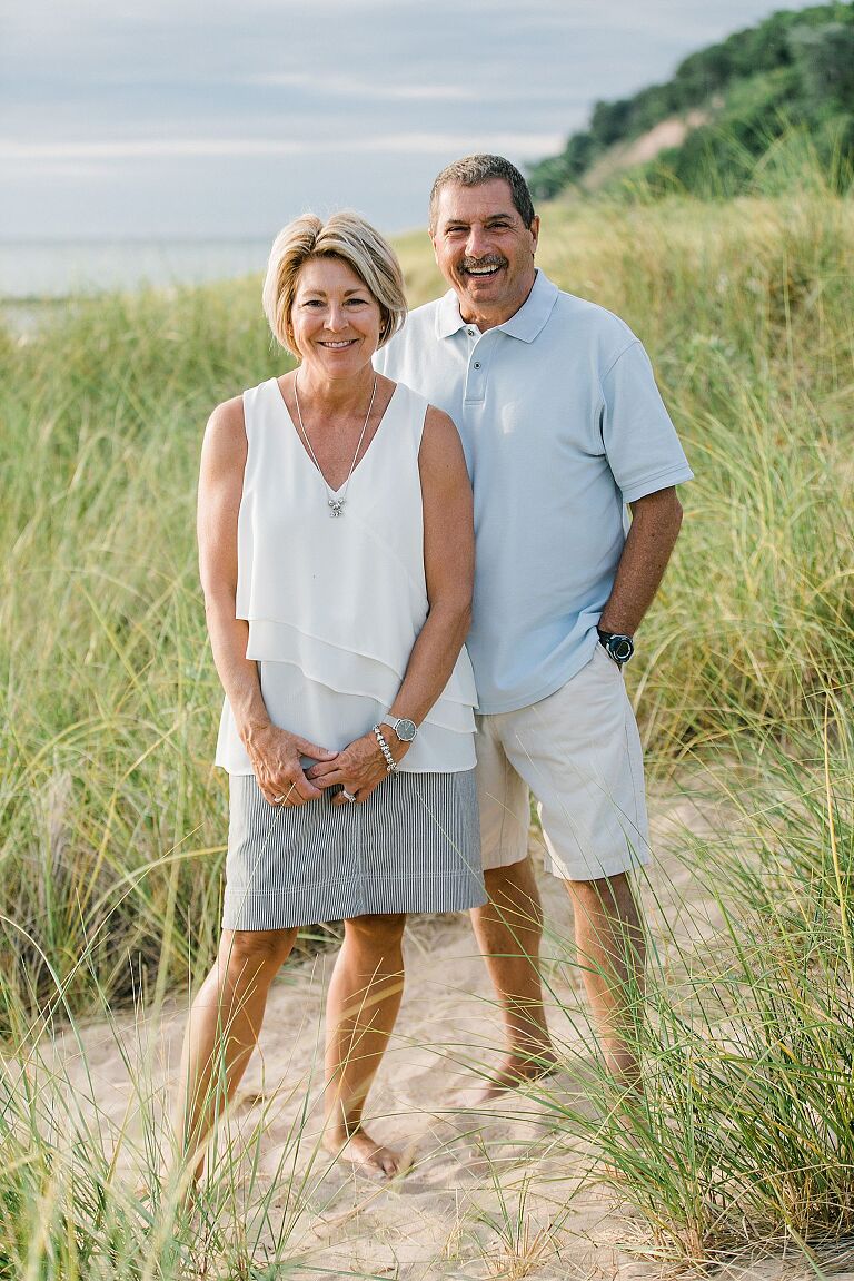 Couple smiling on a beach in Northern Michigan