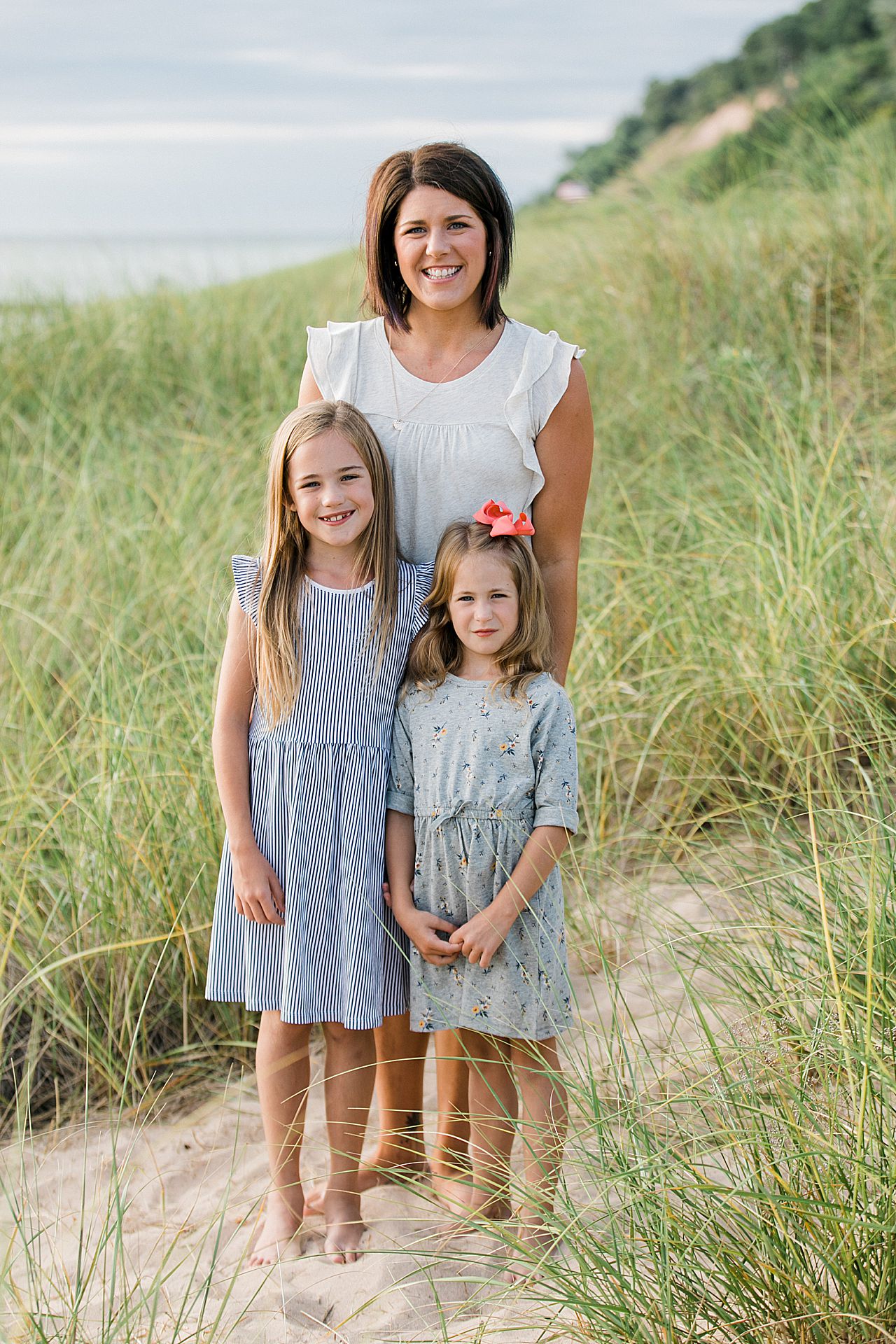 Mother with her two daughters on a beach in Frankfort, Michigan