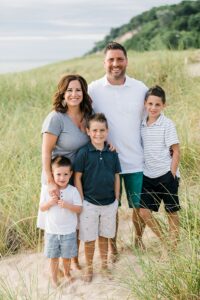 Mother and father with their three sons on a beach