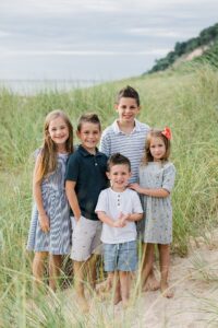 Young cousins surrounded by tall, beach grass