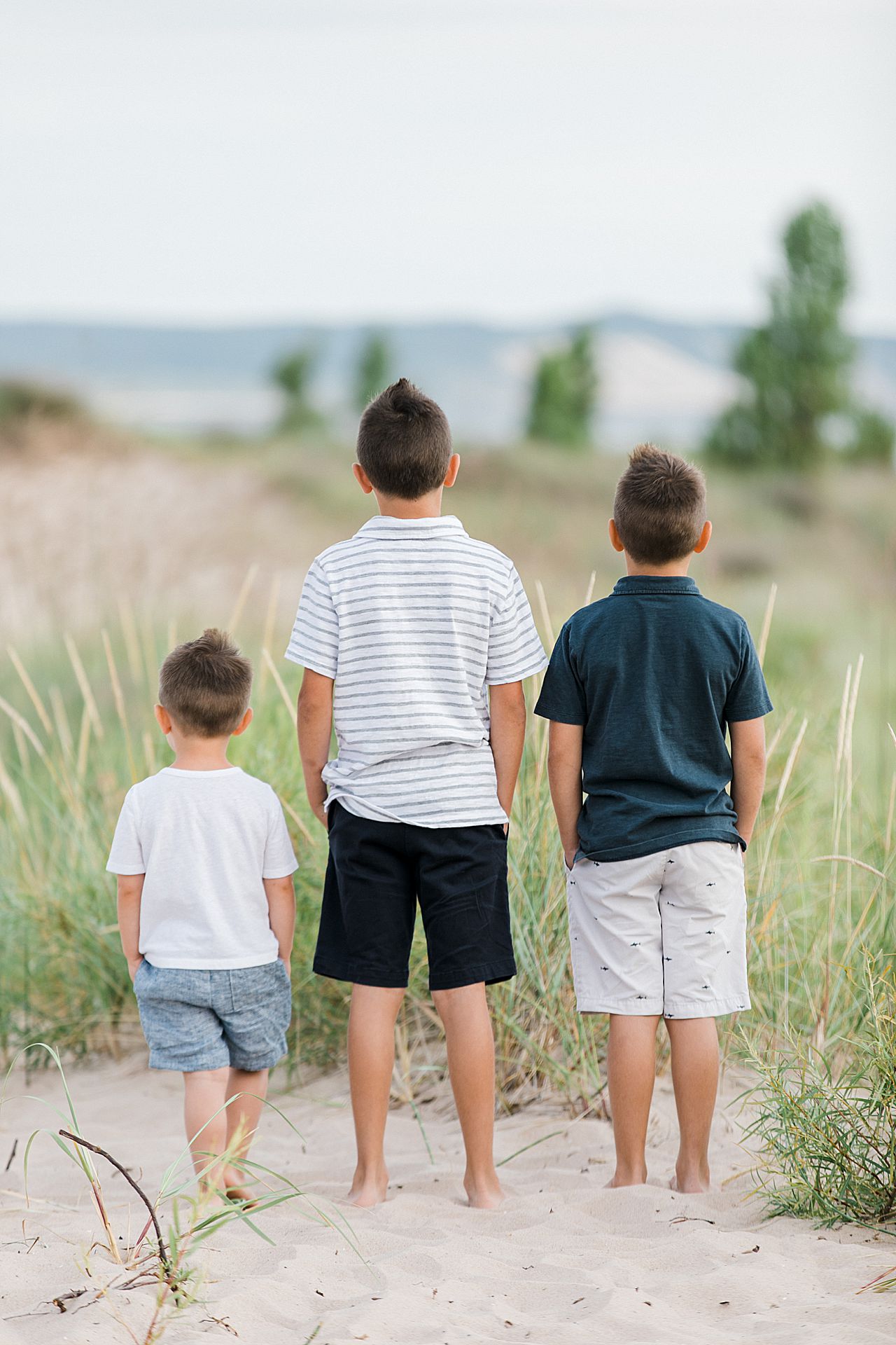 Three young brothers looking out a Lake Michigan