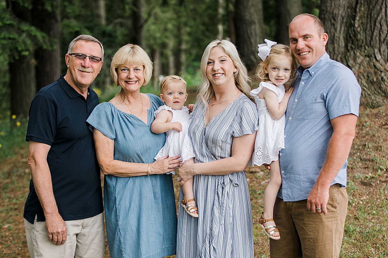 Grandparents with their kids and grandkids in a forest in Northern Michigan