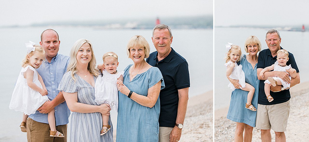 Grandparents and parents holding their two girls on a beach in Michigan