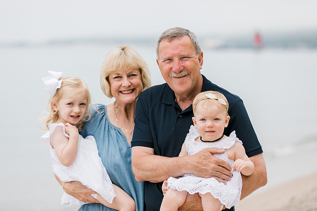 Grandparents carrying their two granddaughters in Northern Michigan