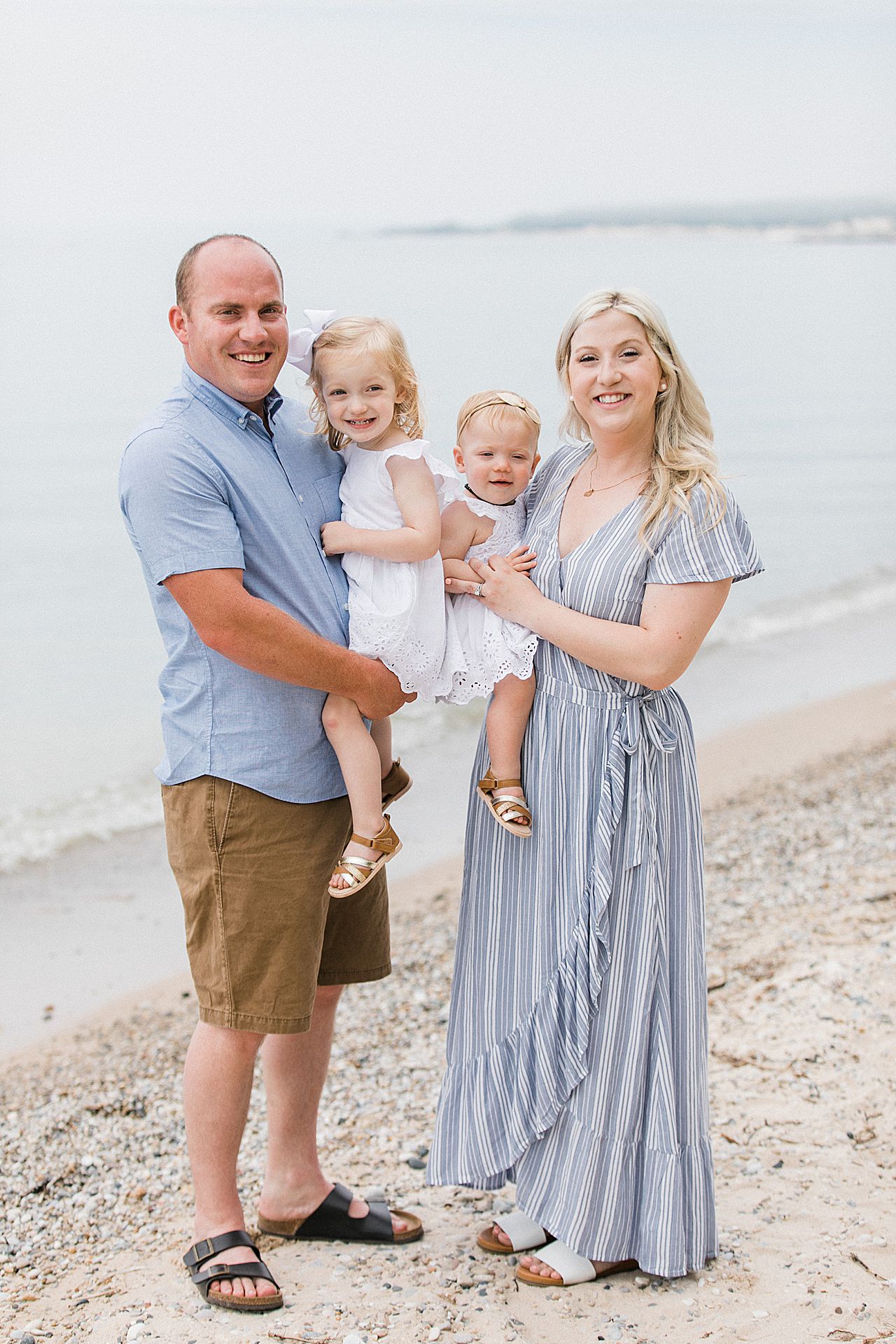 Mother and father holding their two daughters