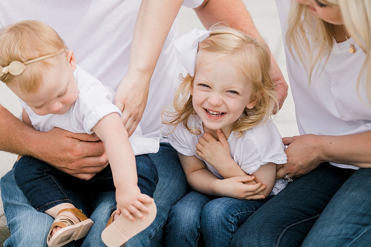 Young girl laughing with her parents in Michigan