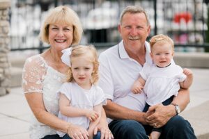 Grandparents sitting with their granddaughters near a marina