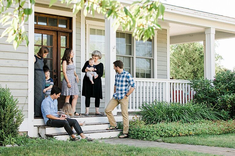 Grandma, kids, and grandkids talking on a porch