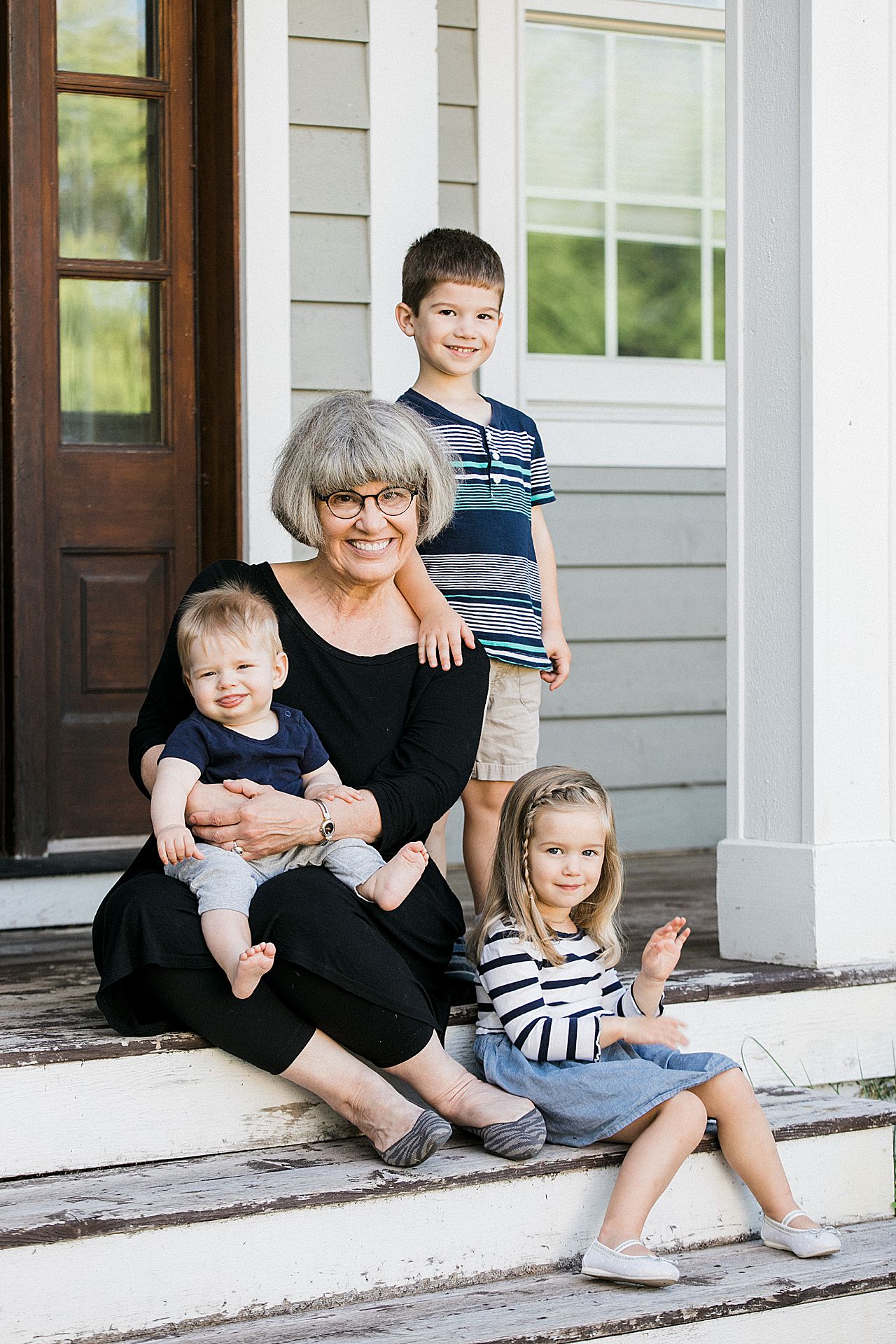 Grandma with three of her grandkids outside in Leland, Michigan