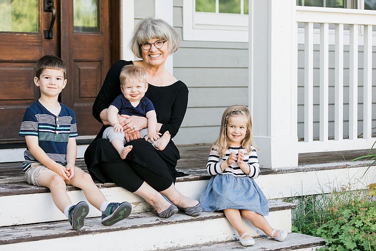 Grandma sitting on a porch with three of her grandkids in Northern Michigan