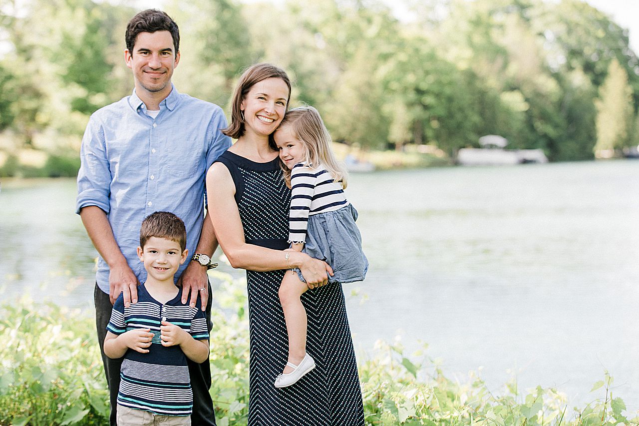 Mother holding her daughter and father posing with his son