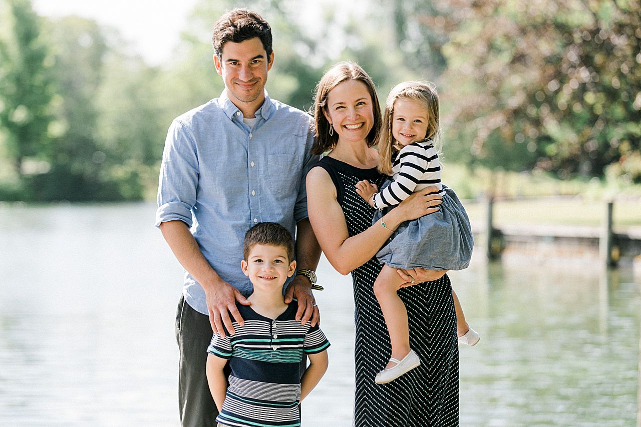 Family of four posing by a lake in Northern Michigan