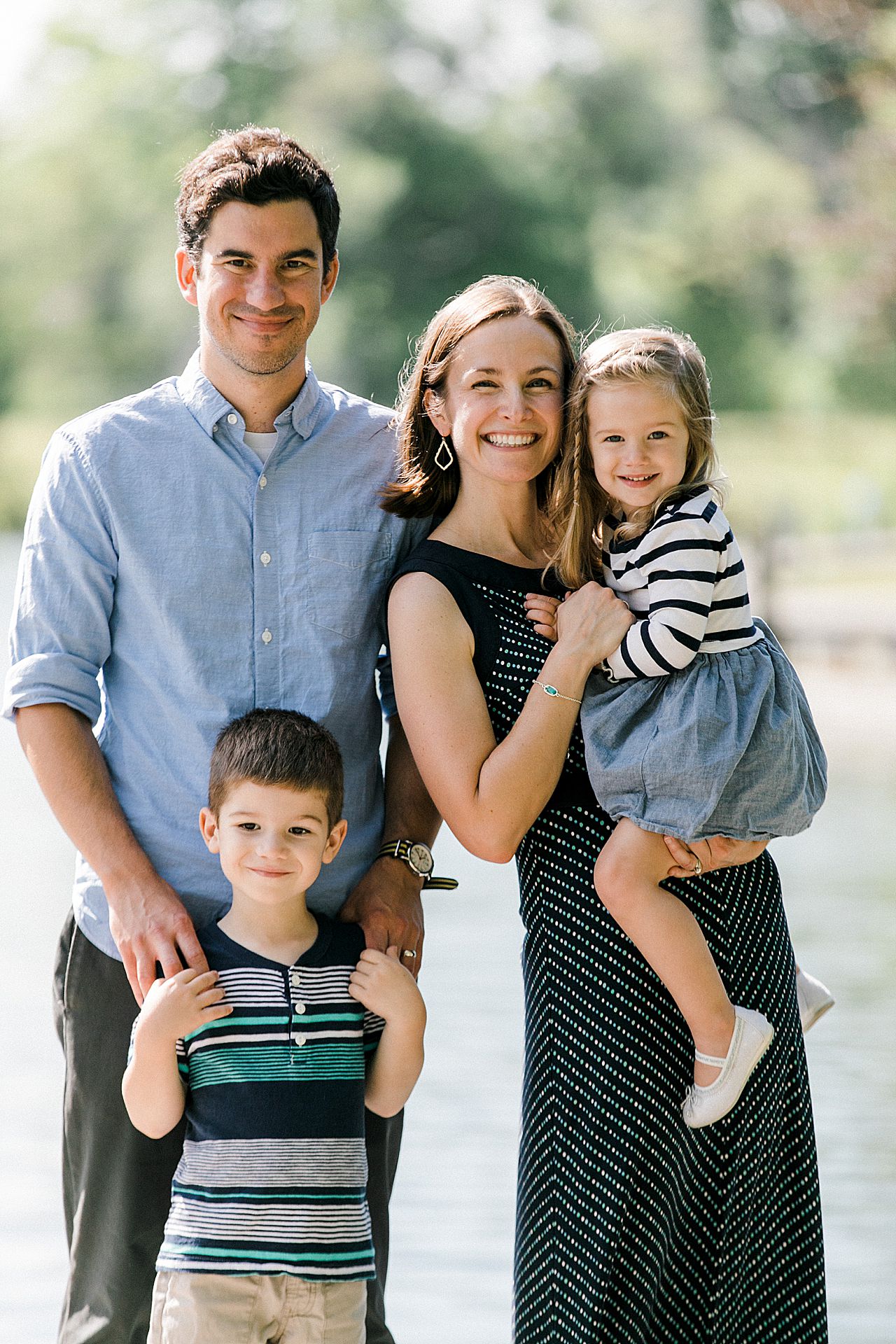 Mother and father smiling with their son and daughter in Leland, Michigan