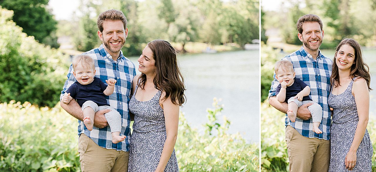 Young family holding their son in front of a lake in Leland, Michigan