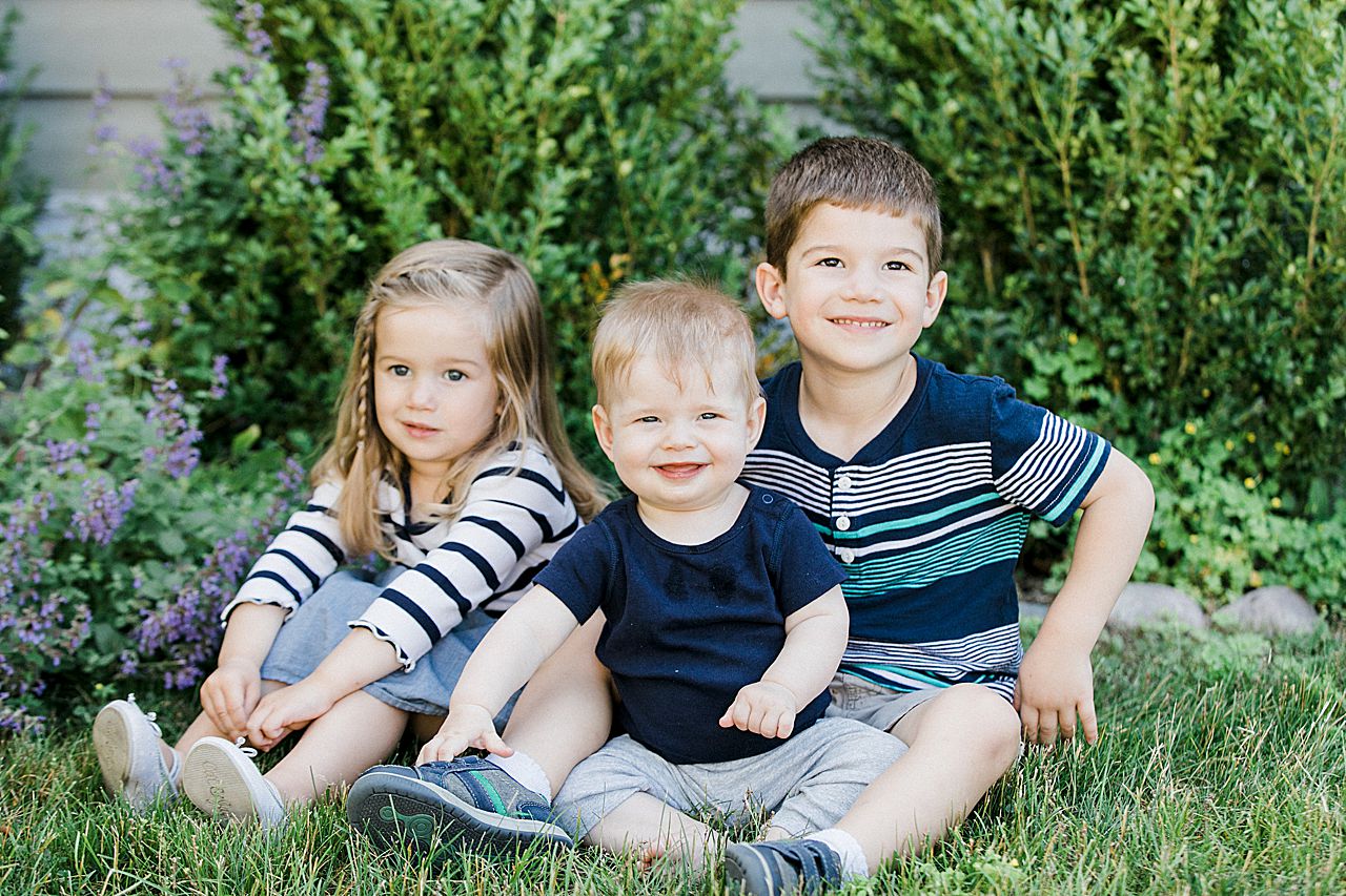 Three cousins sitting in the grass together