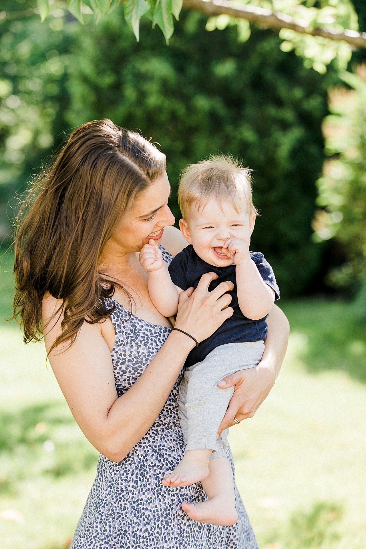 Mother laughing and smiling while holding her young son