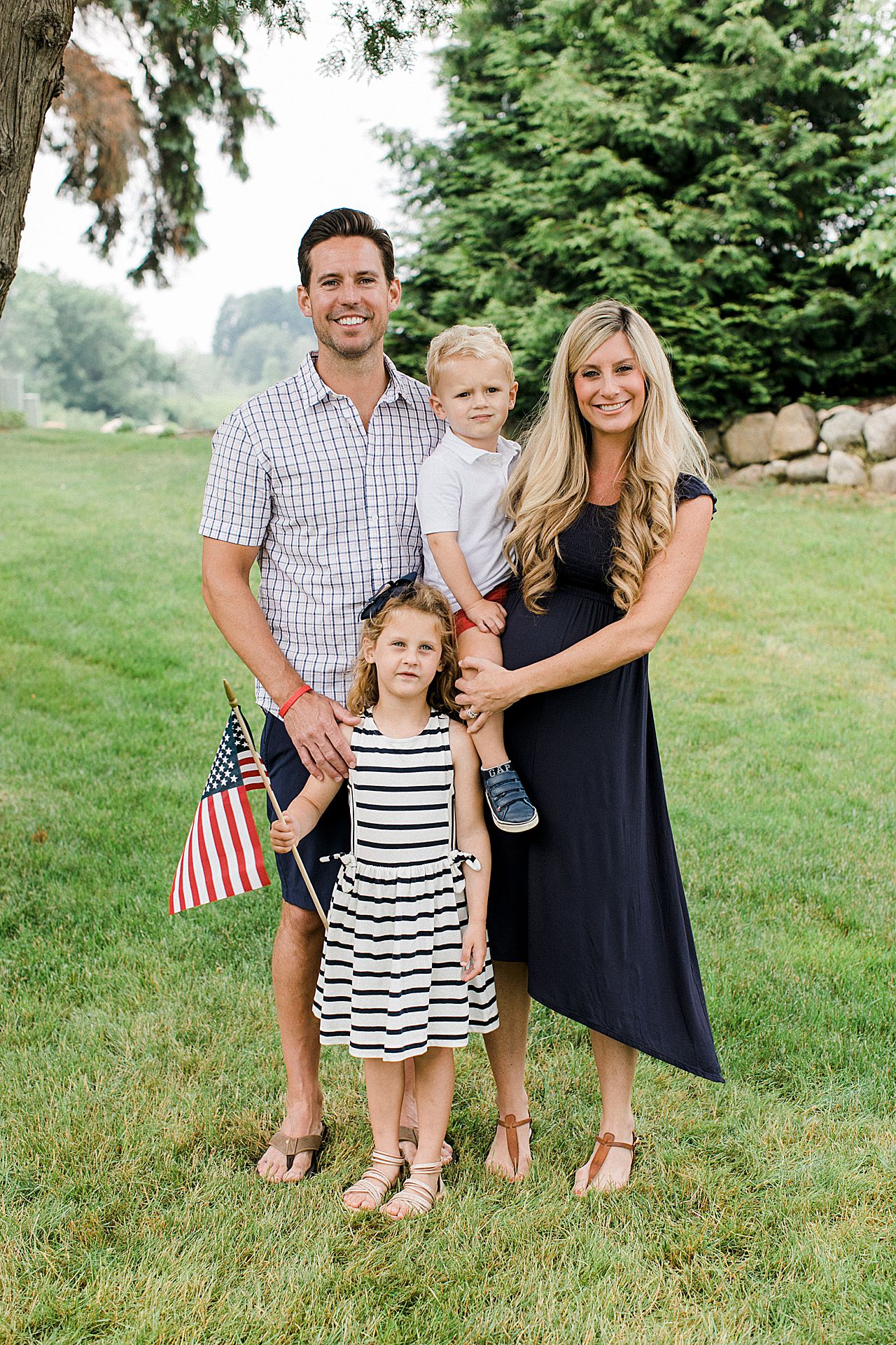 Mother and father with their son, daughter and baby on the way