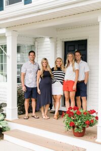 Siblings and their spouses smiling on a porch on the Old Mission Peninsula