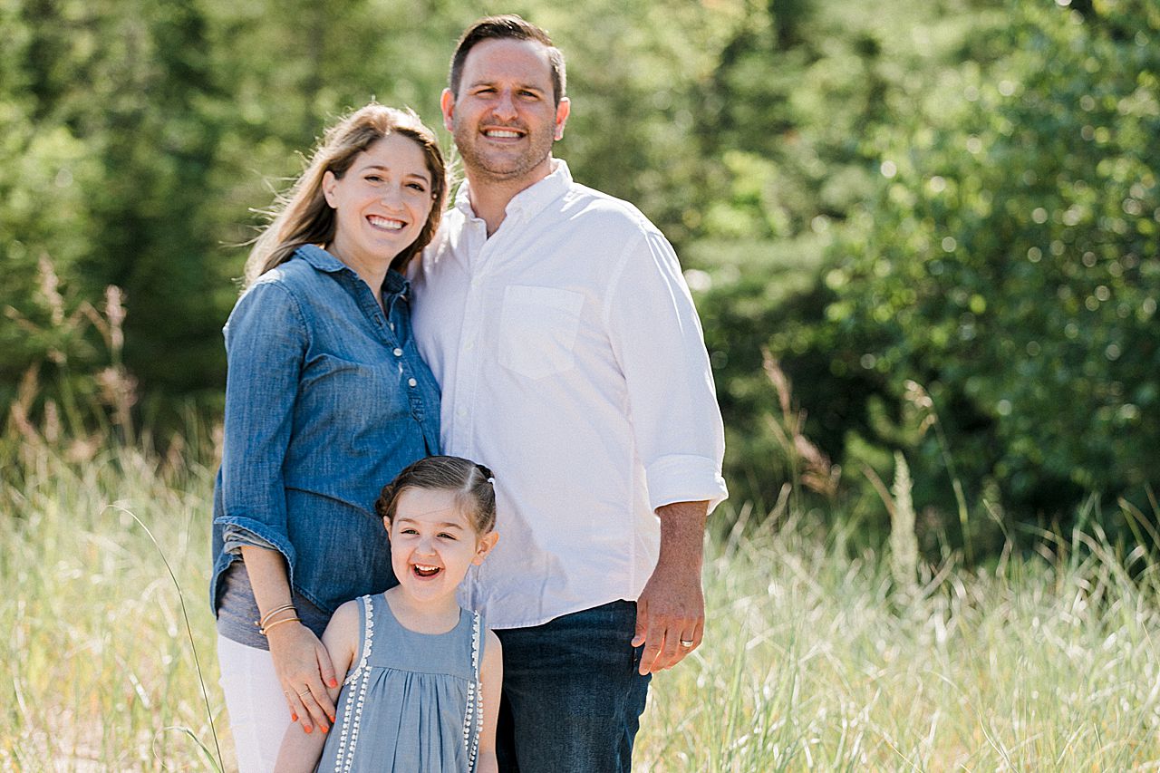 Parents smiling with their daughter in Northern Michigan