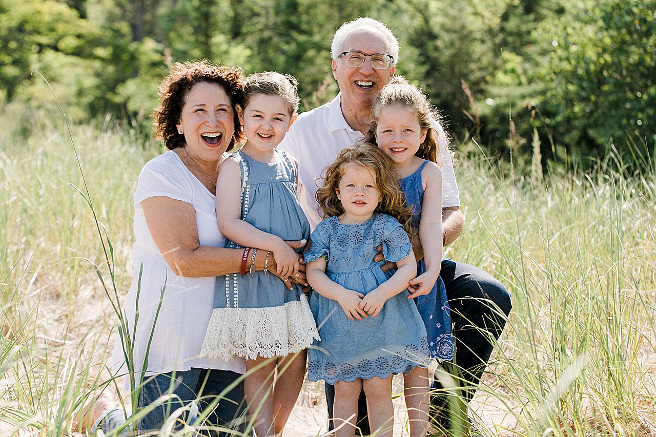 Grandparents with their grandkids on a beach in Petoskey, Michigan